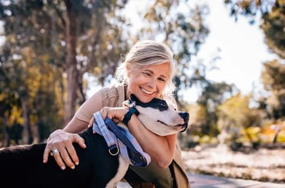 Senior woman enjoying time with a dog outdoors