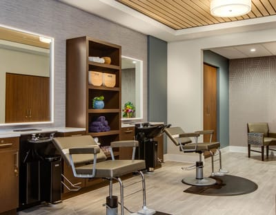 Salon area with styling chairs and mirrors