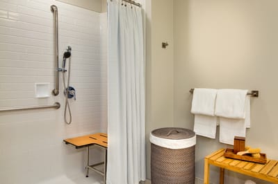Accessible bathroom with grab bars and shower seat