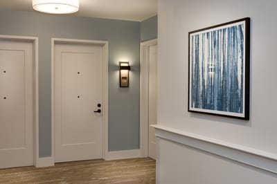 Interior hallway with framed artwork and doors