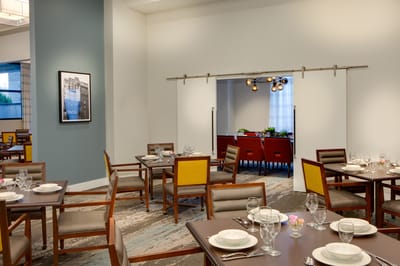 Dining room setup with empty tables and settings