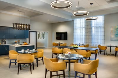 Bright and modern common area with orange chairs
