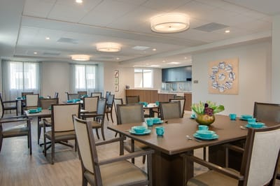 Bright dining room with prepared tables and turquoise dishware