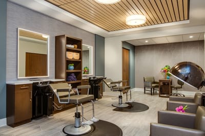 Bright salon area with styling chairs and decor