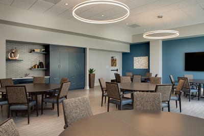 Bright dining area with multiple tables and chairs