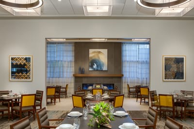 Elegant dining room setup with tables and artwork