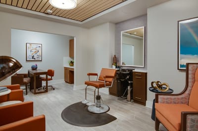 Bright salon area with comfortable seating and styling tools