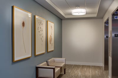 Interior hallway with framed artwork and seating