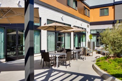 Outdoor patio area with seating and umbrellas