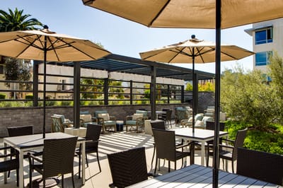 Patio area with umbrellas and seating for residents