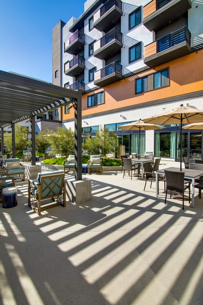 Outdoor seating area with modern furniture and shade