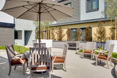 Outdoor seating area with umbrellas and garden