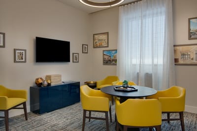 Bright seating area with yellow chairs and a round table