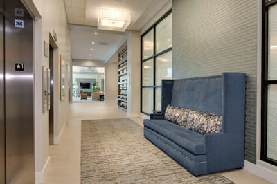 Interior view of a lobby area with seating and elevator