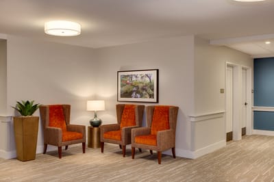 Interior view of a cozy seating area with chairs and artwork