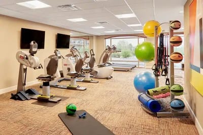 Well-equipped fitness room with exercise machines and equipment