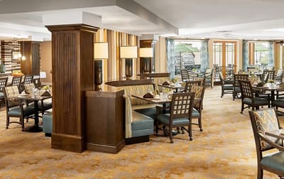 Bright dining room with tables and chairs arranged