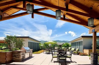 Outdoor patio area with seating and mountains in background