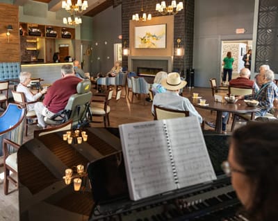 Residents socializing in a common area with live music
