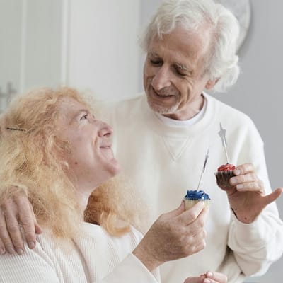Residents celebrating with cupcakes in a cheerful setting