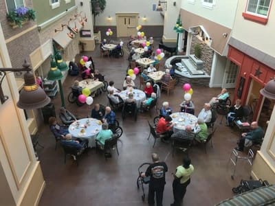 Residents celebrating in a social activity room