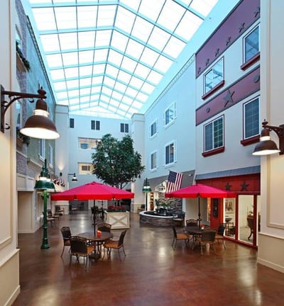 Indoor common area with seating and umbrellas
