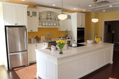Bright kitchen area with modern decor and fresh flowers