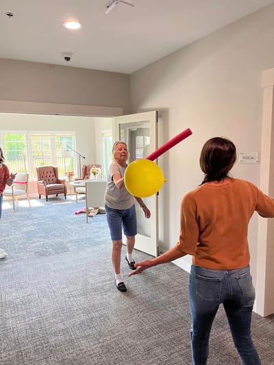 Residents participating in a fun indoor activity with balloons