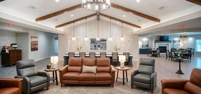 Bright common area with seating and kitchen view