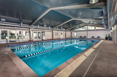 Indoor swimming pool area with ample lighting