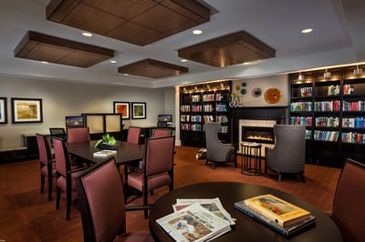 A cozy common area with bookshelves and seating