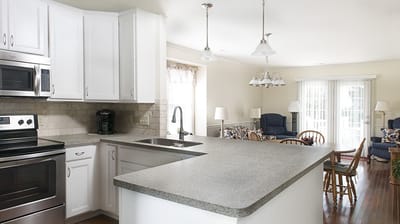 Bright kitchen area with seating and living space