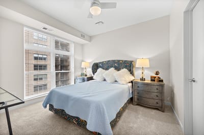 Cozy bedroom setup with decorative bedding and lamps