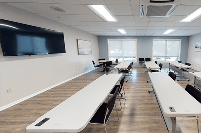 Bright interior meeting room with tables and chairs
