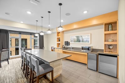 Bright common area with seating and a kitchenette