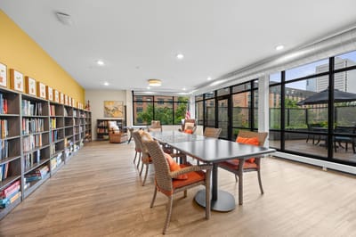 Bright common area with a large table and seating