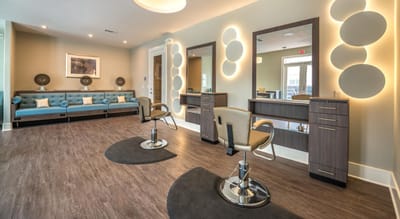 Beauty salon area with mirrors and styling chairs