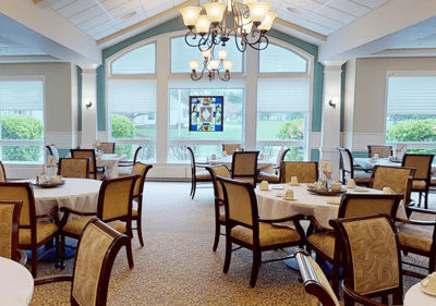 Interior dining area with tables and a stained glass window