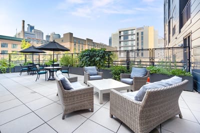 Outdoor patio area with seating and greenery