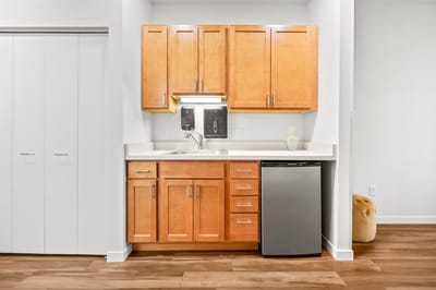 Kitchenette with wooden cabinets and modern appliances