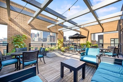 Outdoor seating area with plants and tables