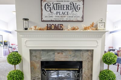 A cozy common area with a fireplace and decor