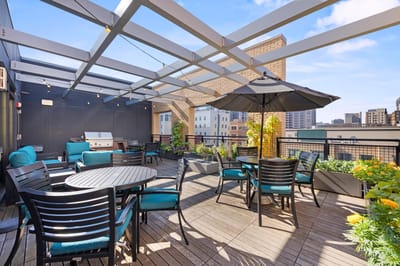 Outdoor terrace with seating and greenery