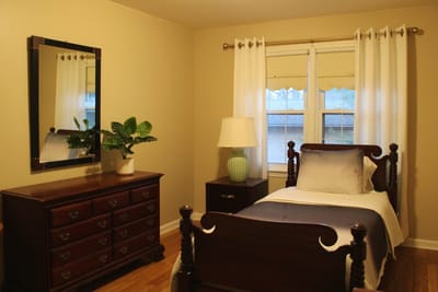 Cozy private room with a bed and dresser