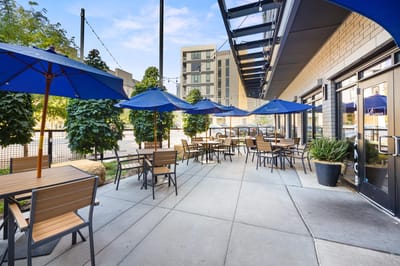 Outdoor dining area with tables and umbrellas