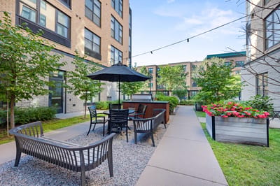 Outdoor seating area with greenery and flowers