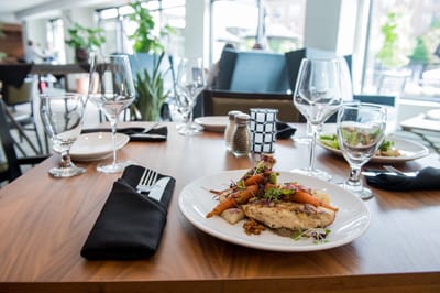 Beautifully set dining table with a plated meal