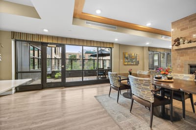 Bright common area with large windows and seating