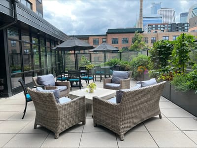 Patio area with seating and greenery
