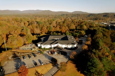 Aerial view of the Oaks at Ellijay surrounded by fall foliage